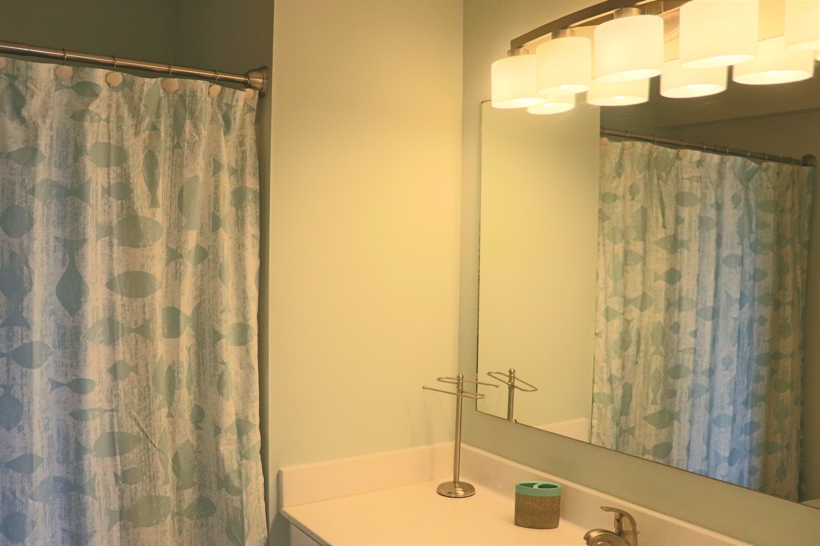 Refresh in your modern bathroom featuring stylish shower curtains, warm lighting, and thoughtful touches for your comfort.