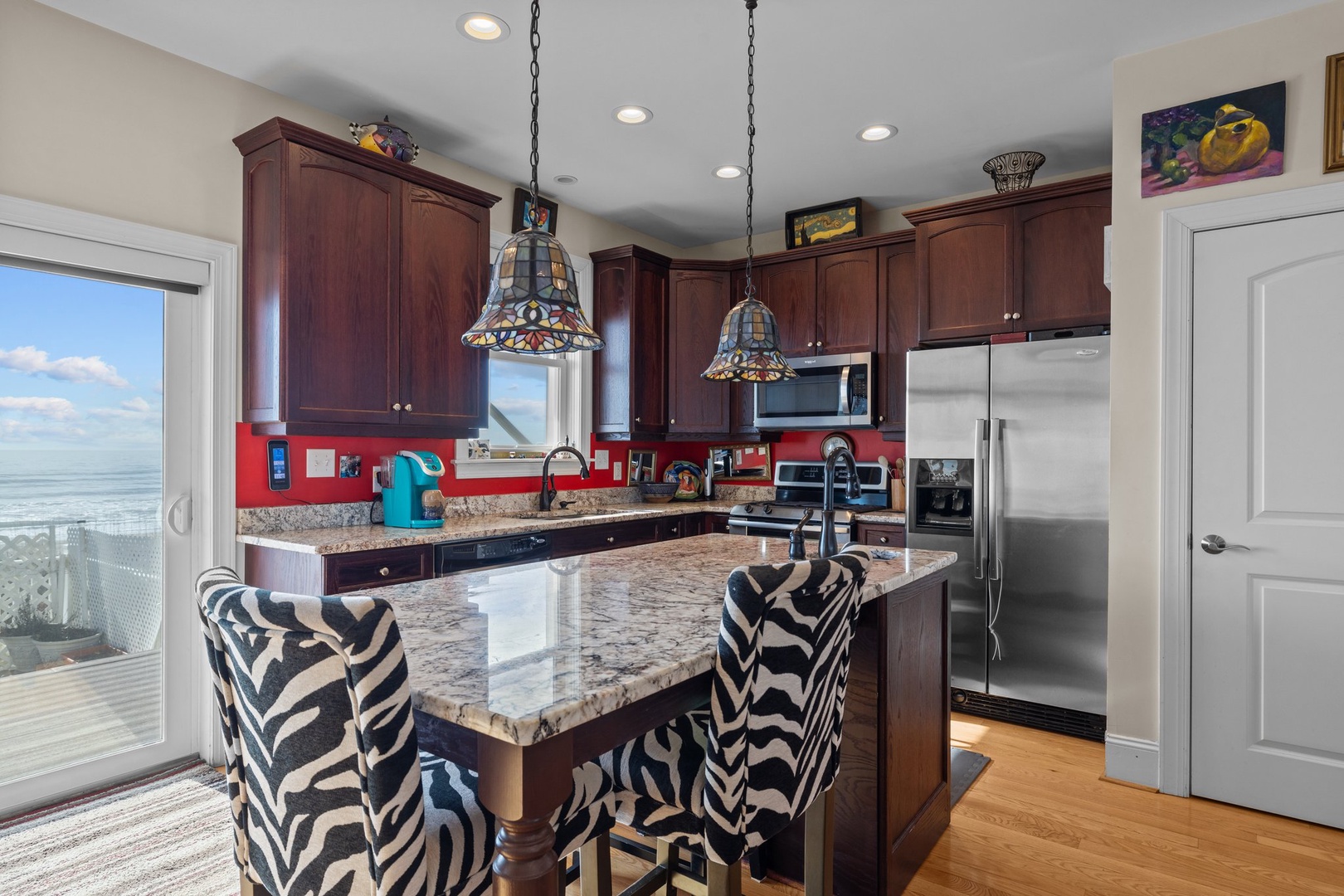 Your gourmet kitchen awaits with granite counters, stainless appliances, and stunning ocean views—perfect for morning coffee while watching the waves.