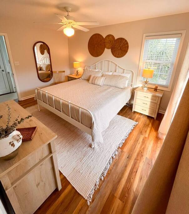 Drift off to sleep in your cozy bedroom with warm wood floors, soft linens, and charming vintage touches.