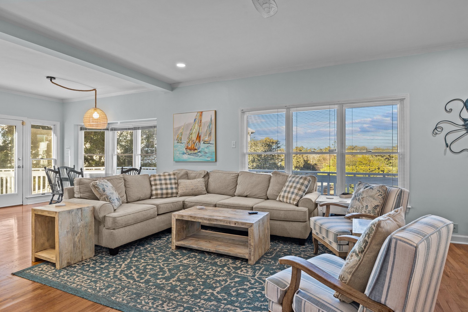 Sink into plush sectional seating where nautical charm meets comfort. Natural light floods your bright living space through expansive windows.