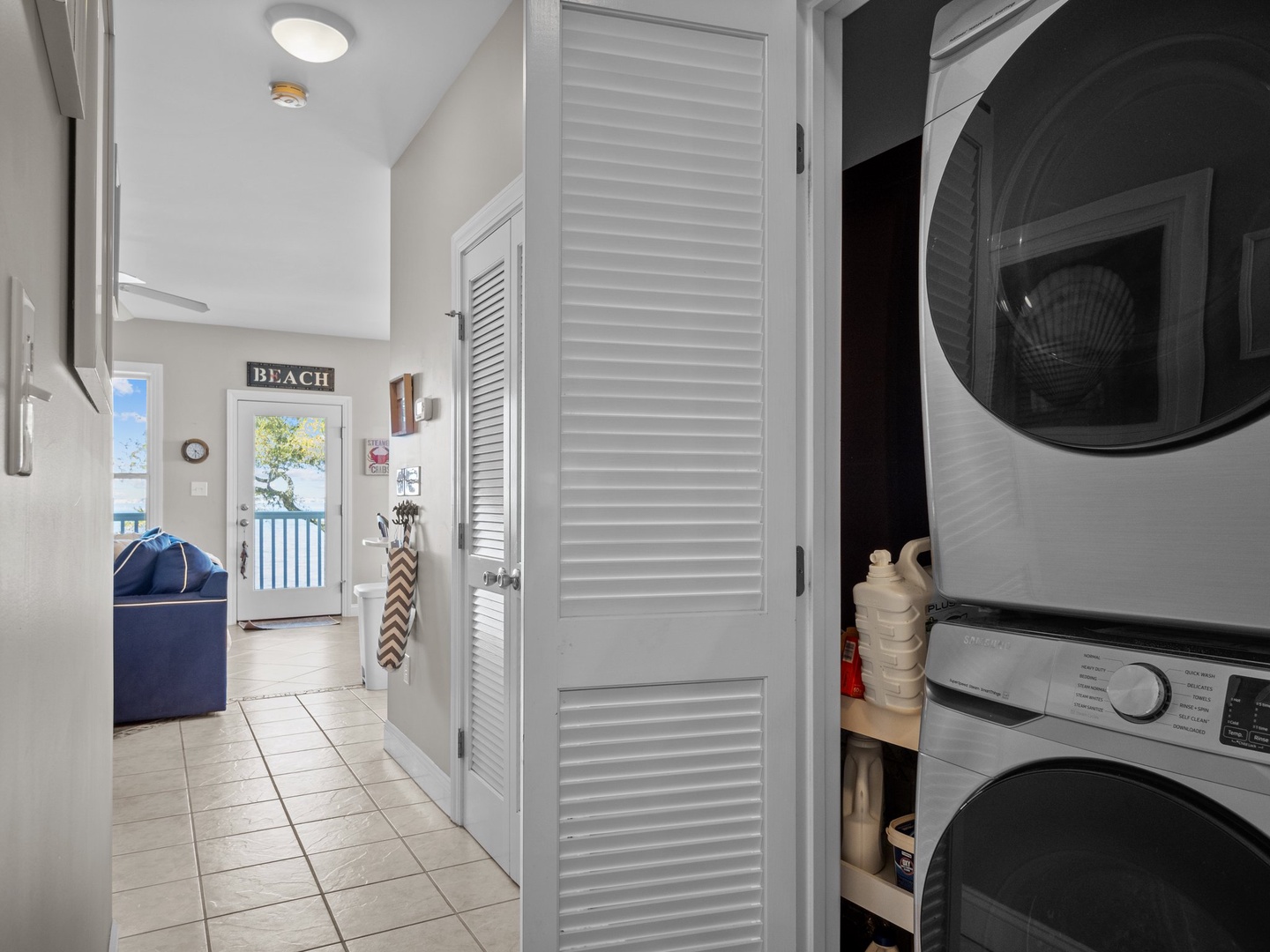 Your private laundry nook keeps beach gear fresh with stackable washer-dryer and clever storage solutions.