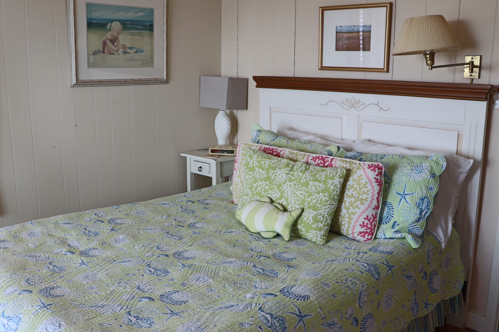 Your coastal bedroom sanctuary features ocean-themed linens and charming beach artwork, perfect for peaceful nights after seaside adventures.