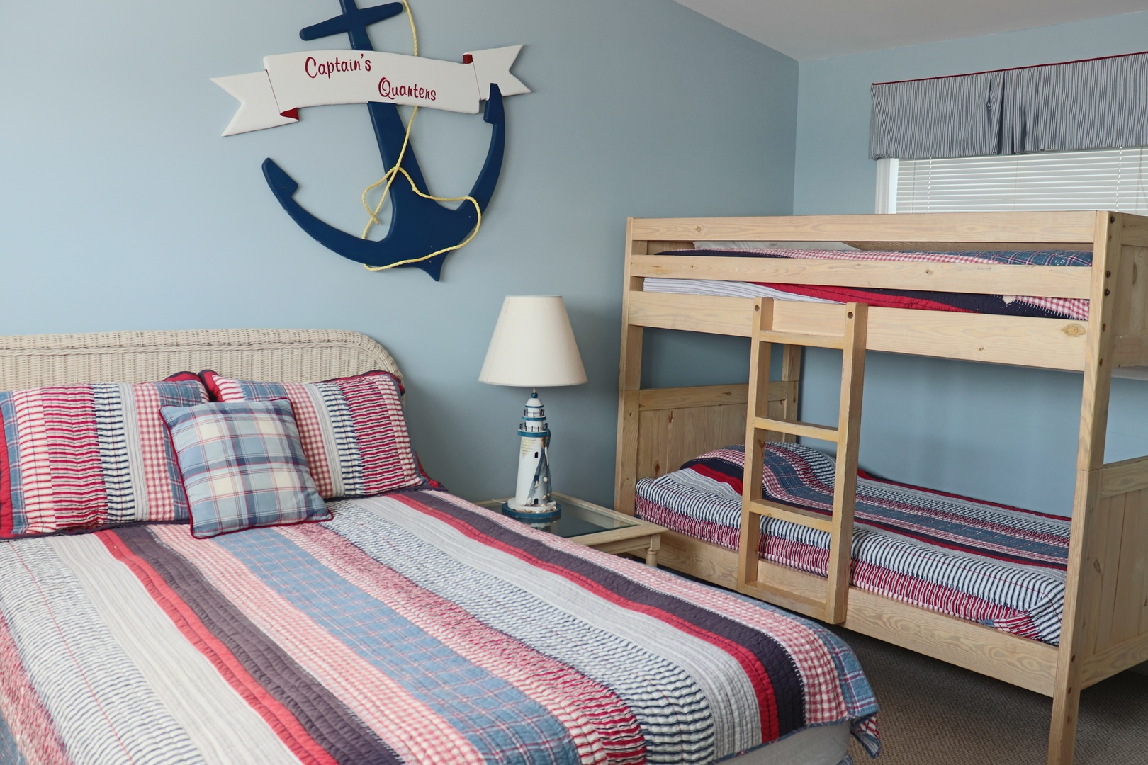 Your family can drift off to nautical dreams in this charming Captain's Quarters, where colorful striped bedding and maritime décor create a cozy seaside escape.