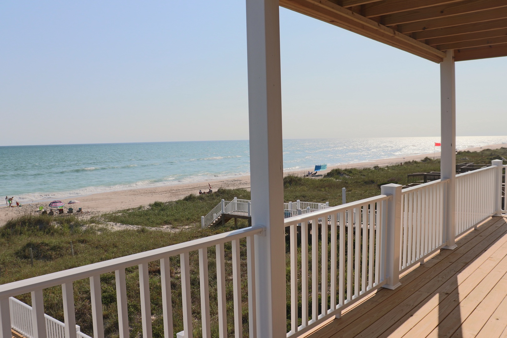 Sip your morning coffee on this stunning deck while waves gently roll onto the pristine beach below.
