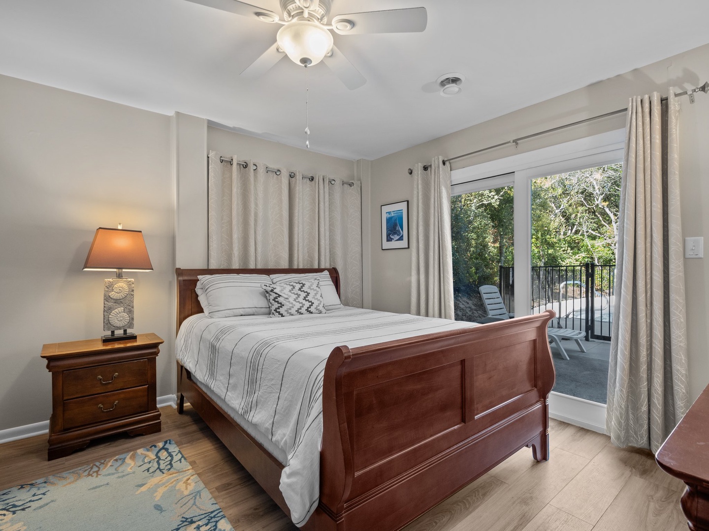 Drift off peacefully in your elegant bedroom, where rich wood furnishings and soft linens create a restful retreat with private balcony access.