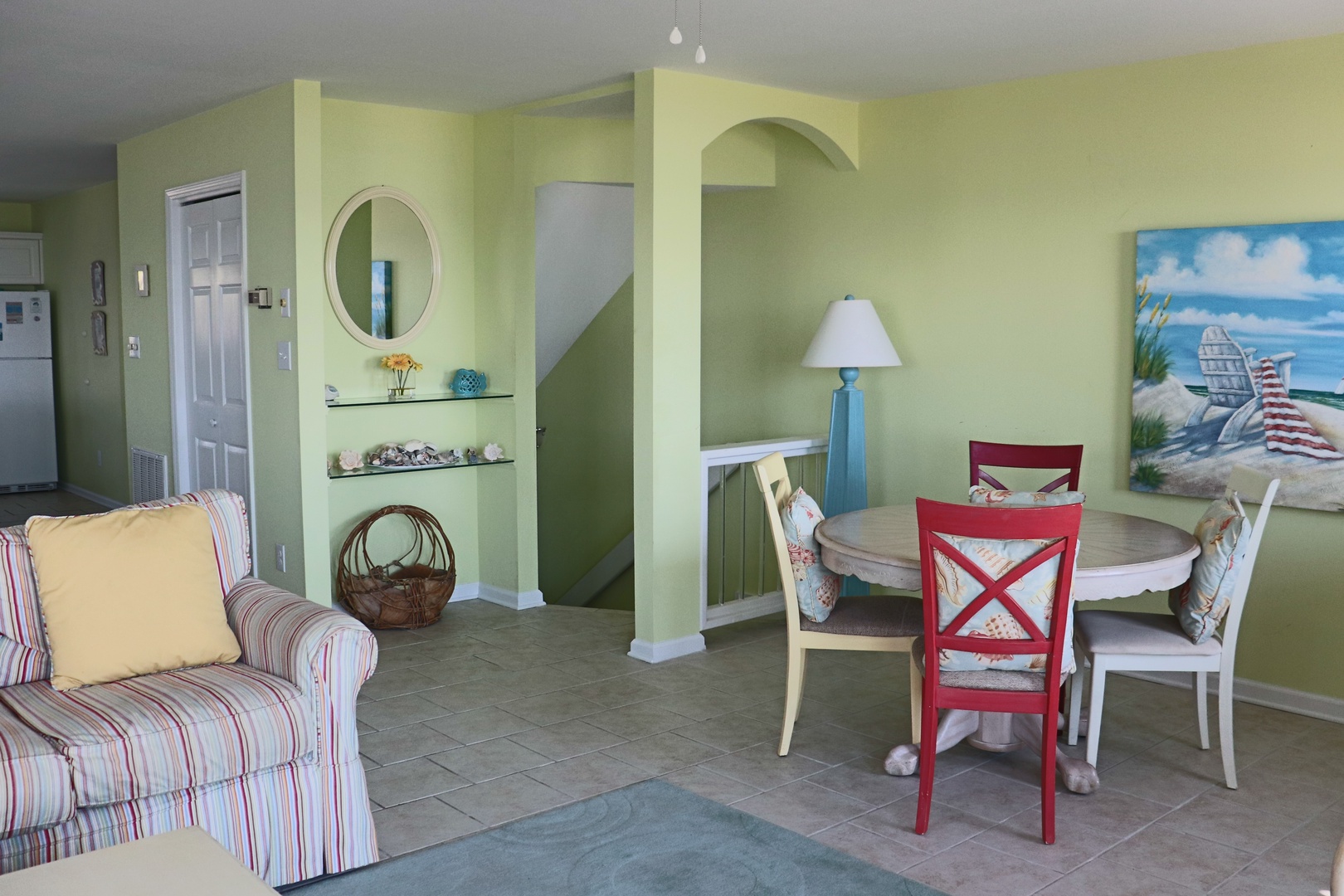 Your open living space combines coastal charm with comfort, featuring cheerful colors and thoughtful touches for memorable gatherings.