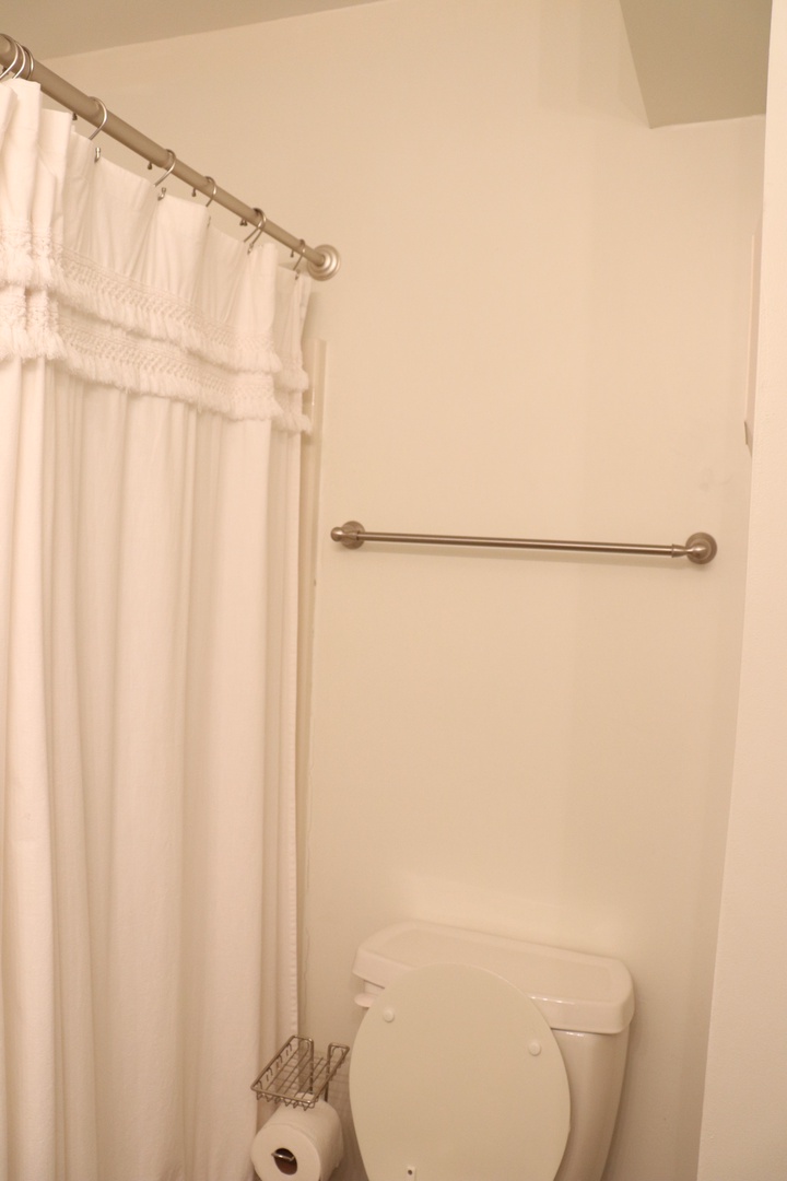 Your private bathroom features a spacious shower with grab bar for safety and comfort during your stay.