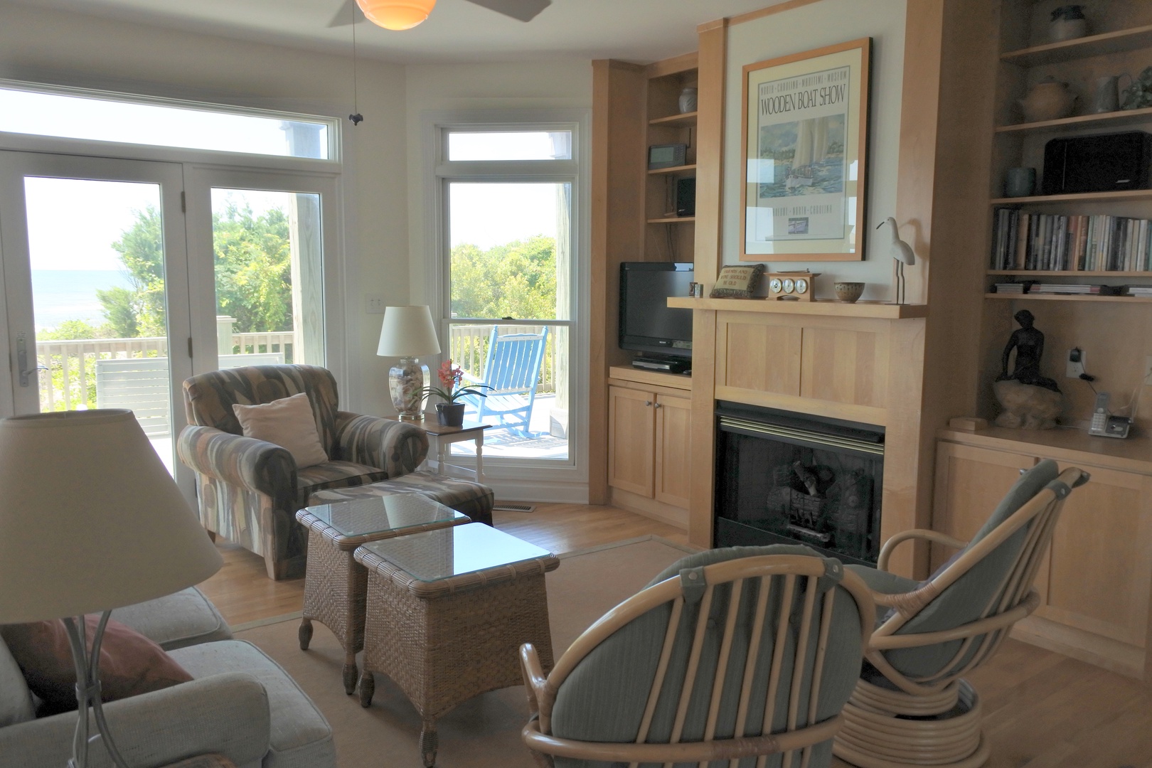 Settle into your bright living room with cozy seating, warm fireplace, and peaceful views through French doors leading to your private deck.