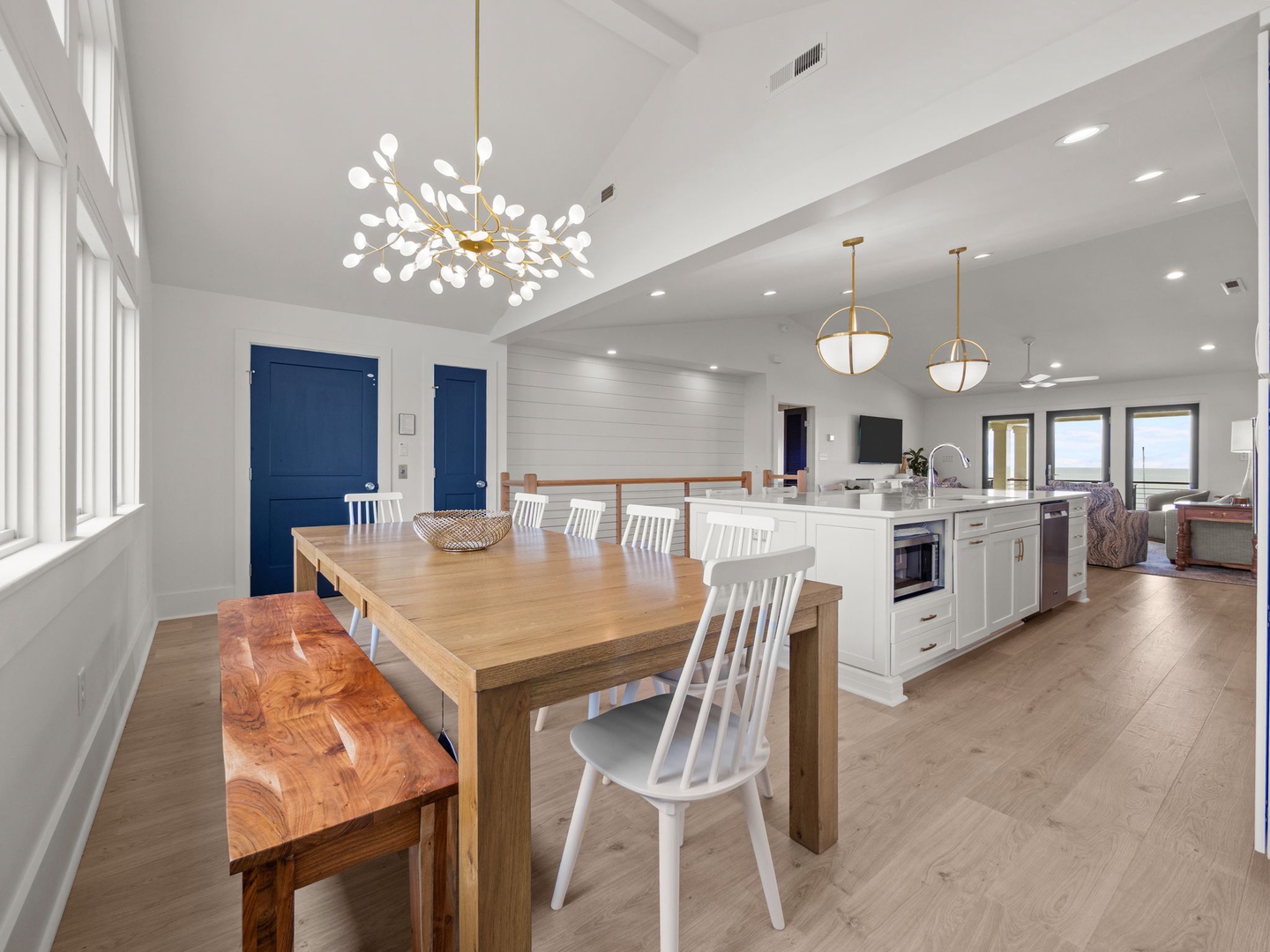 Your spacious open-plan living awaits with a stunning kitchen island, elegant dining table, and modern fixtures creating the perfect space for memorable meals.