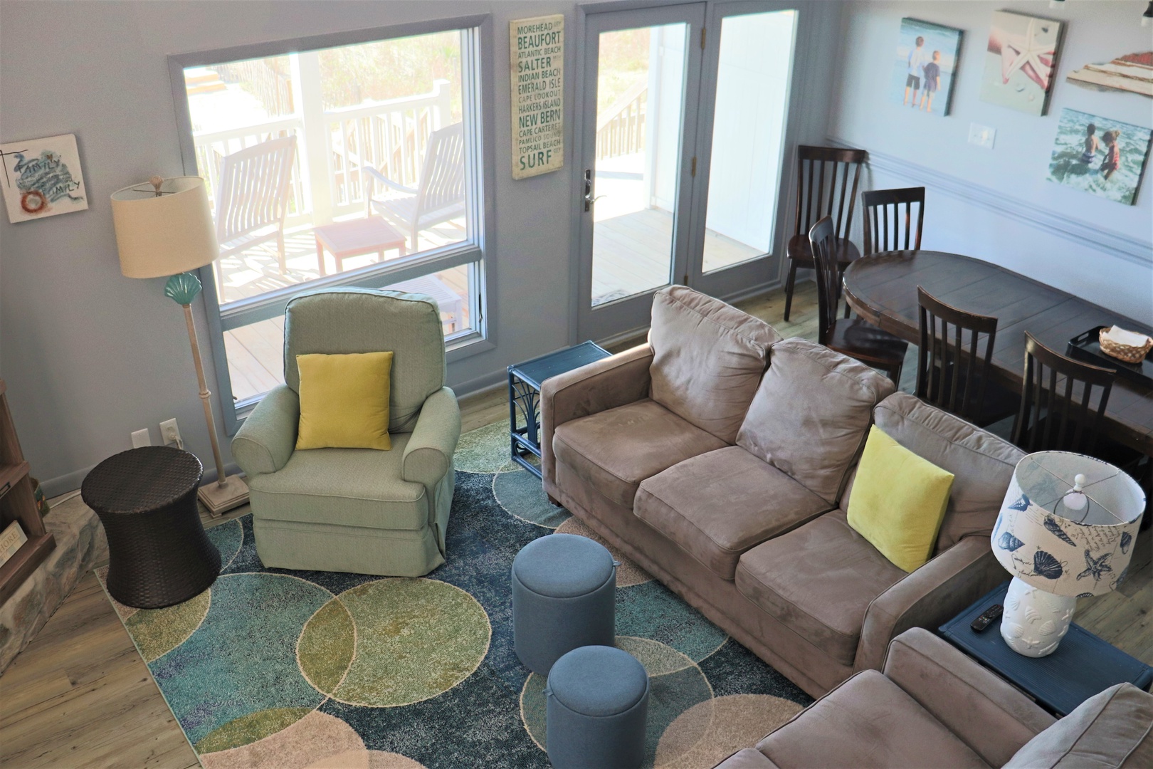 Sink into plush coastal comfort in your bright living space, where cheerful yellow accents and ocean-themed touches create the perfect beach retreat.