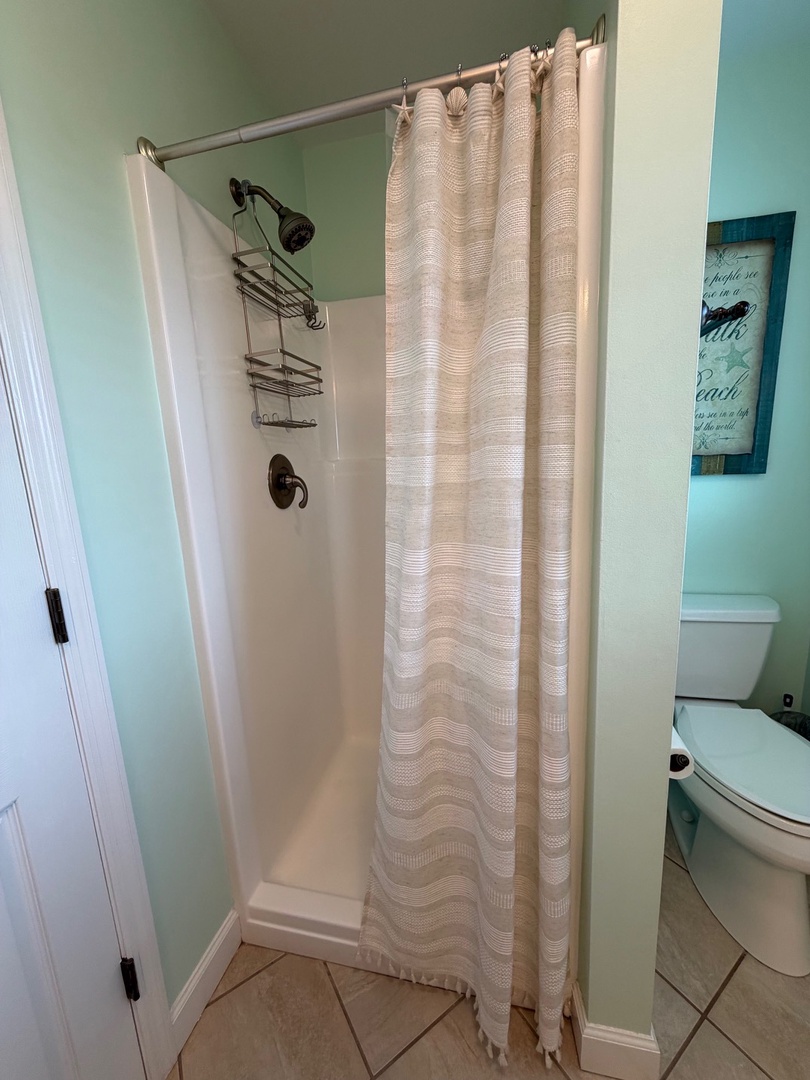Unwind in your private bathtub with elegant curtains and thoughtful amenities for the perfect relaxing soak.