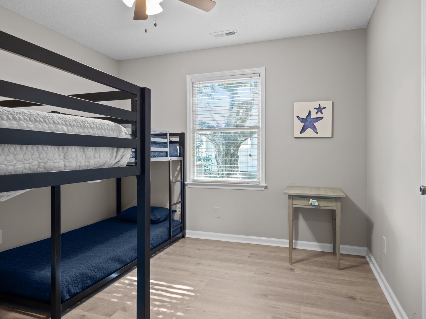 Your kids will love this cozy bunk room with sturdy beds, natural light, and charming coastal décor for perfect sleep.