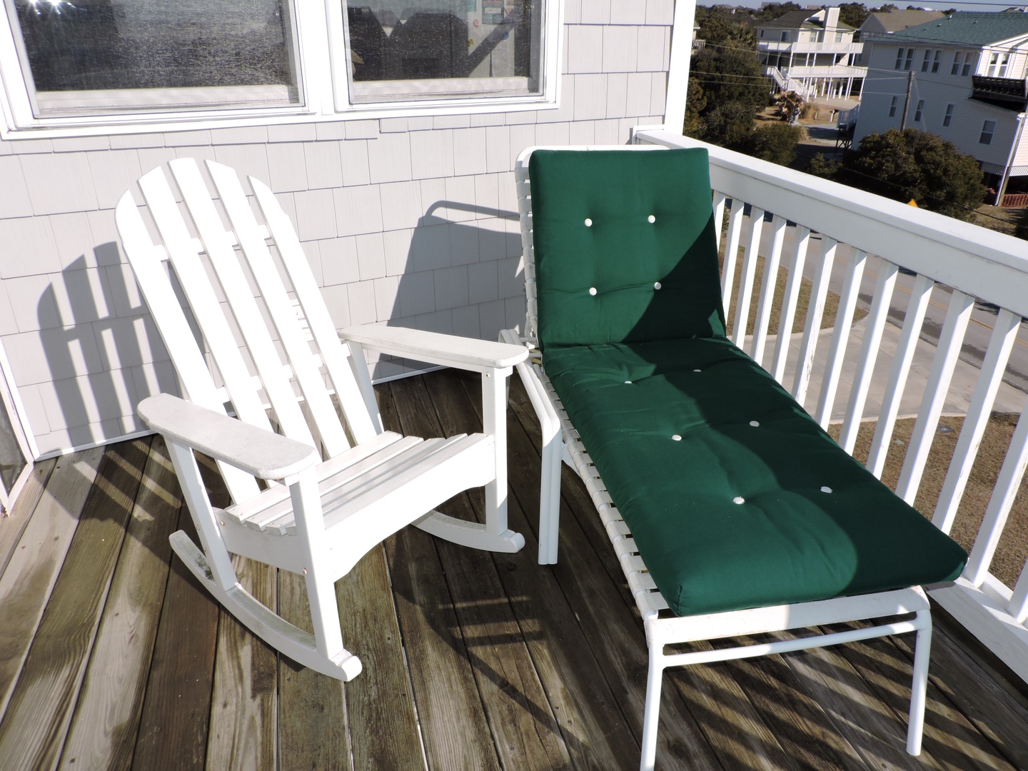 Relax on your private balcony with comfortable seating while enjoying peaceful neighborhood views.