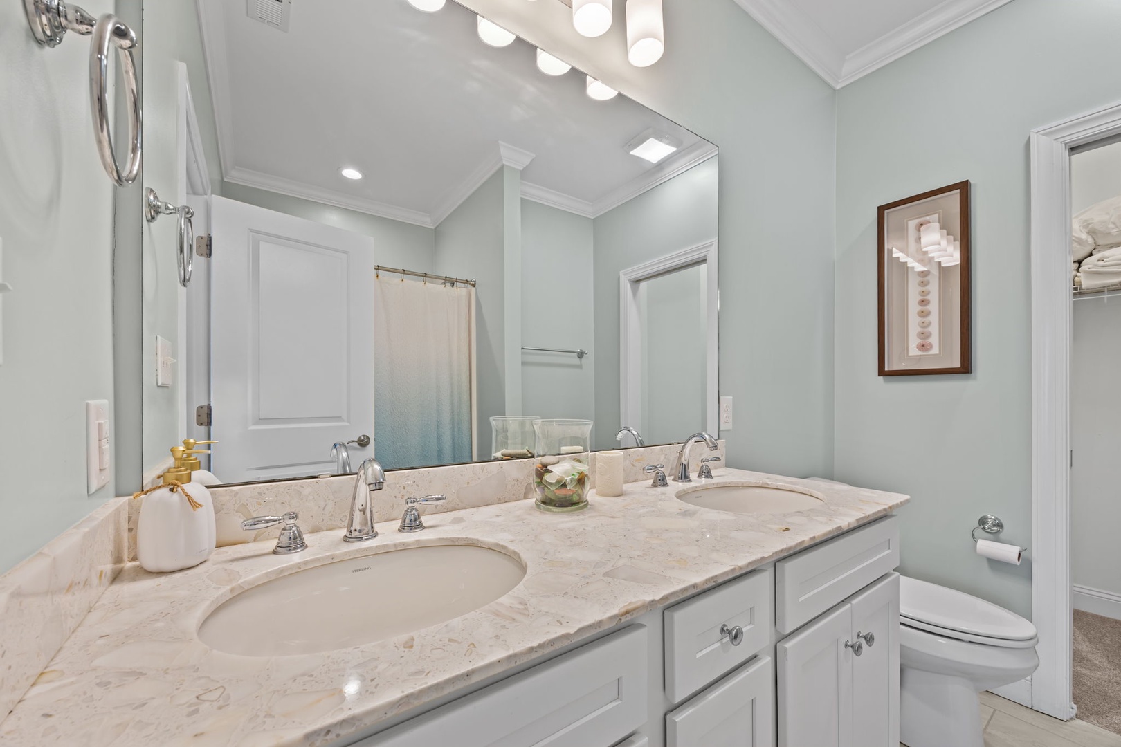 Step into your elegant marble bathroom featuring dual vanities, perfect lighting, and all the luxuries you need for a refreshing start to your day.