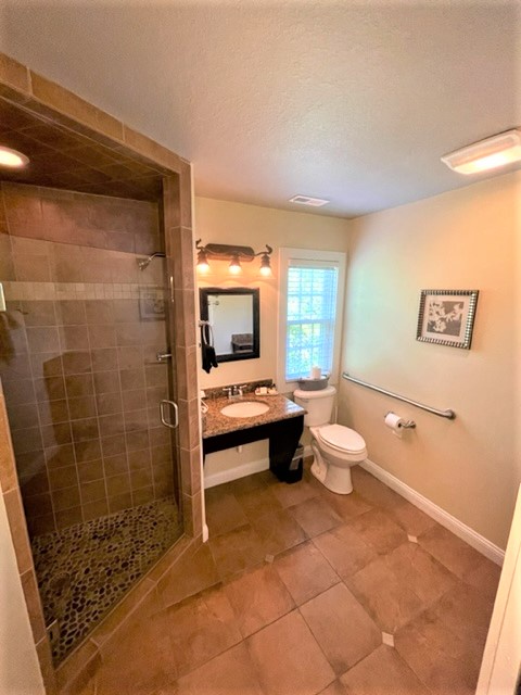 Your private sanctuary features a luxurious walk-in shower with stone tiles and a modern vanity where you can refresh after your adventures.