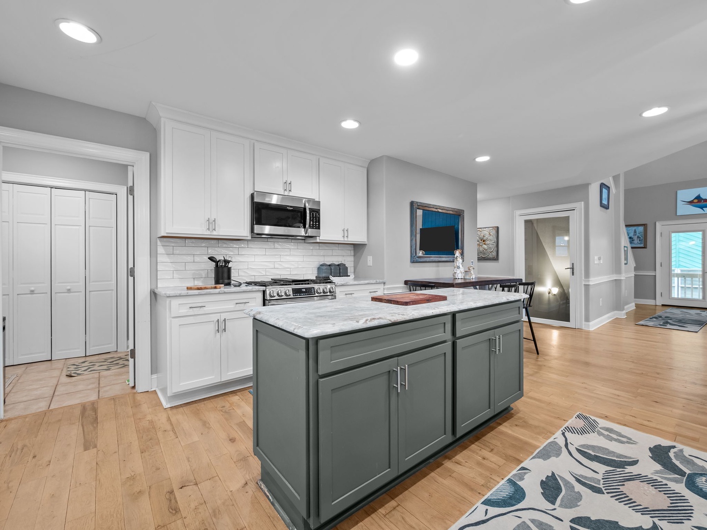 Your gourmet kitchen features marble countertops, stainless appliances, and a spacious island perfect for cooking memorable vacation meals together.