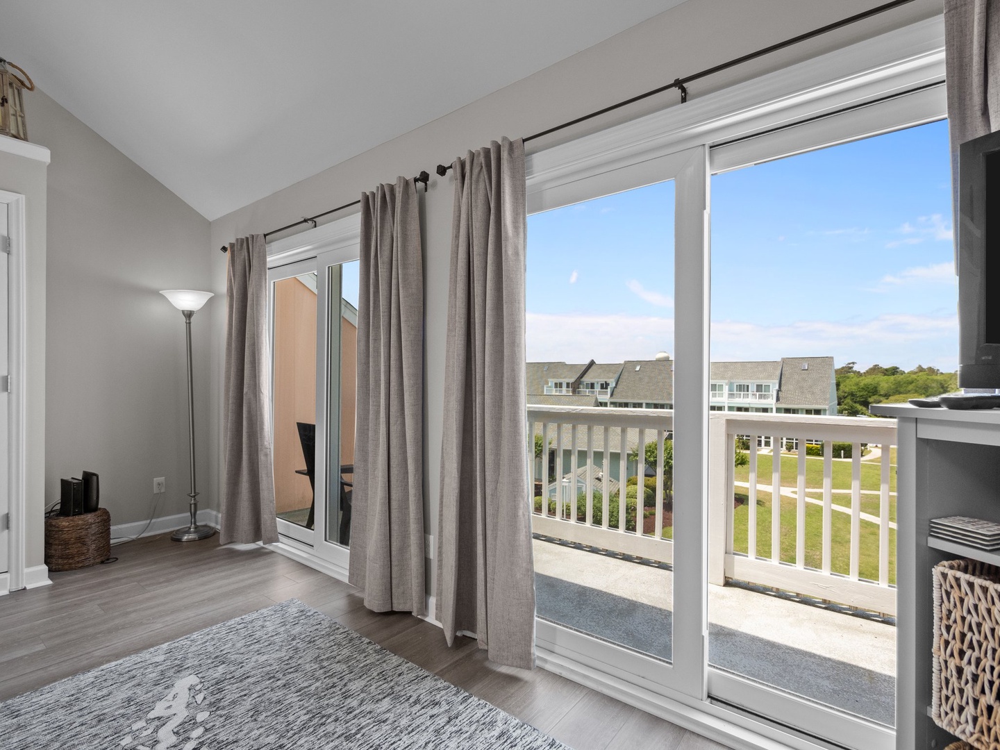 Step out onto your private balcony and soak in panoramic views of the peaceful residential area below, framed by soft natural light.