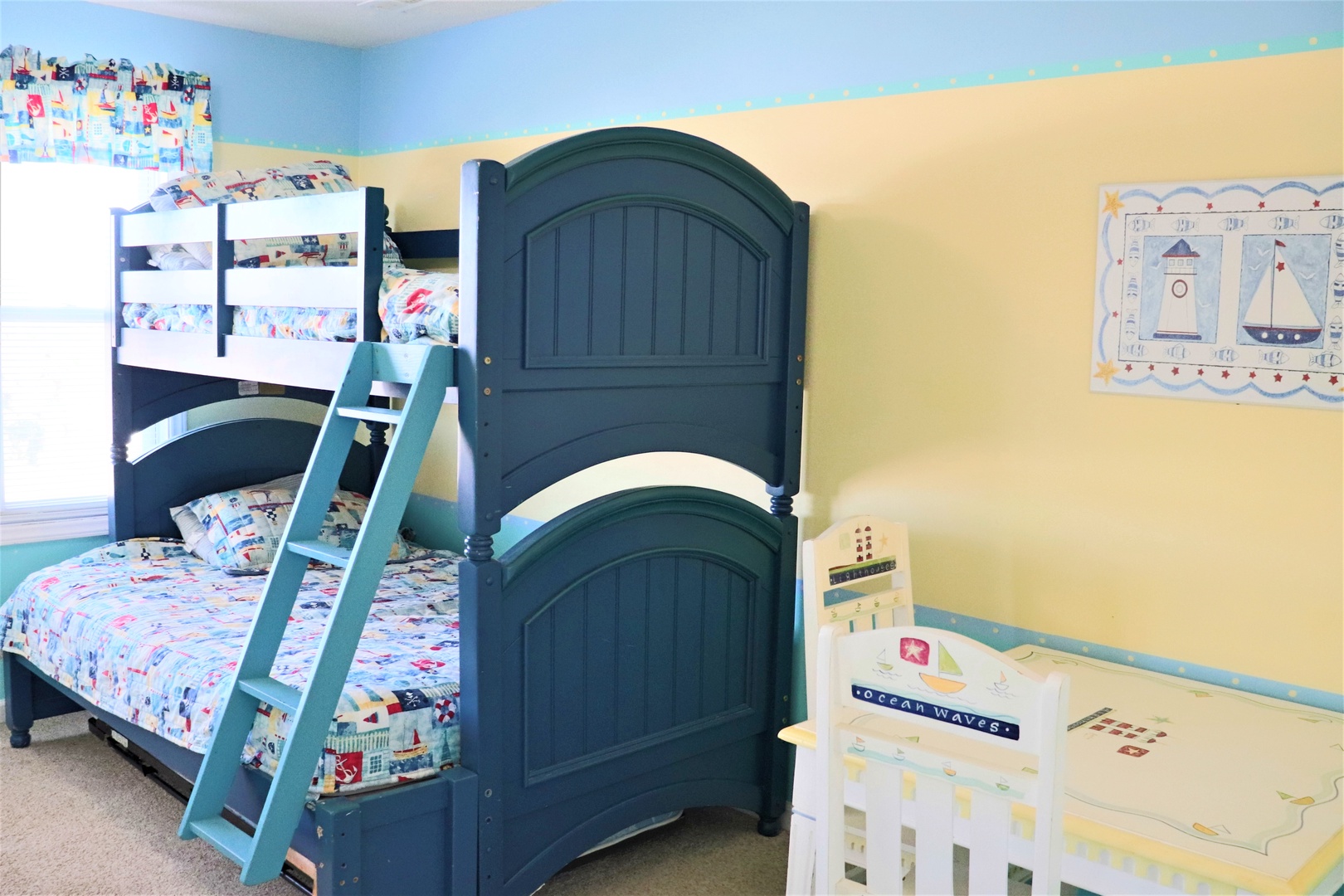Your kids will love this cheerful bedroom with sturdy bunk beds and nautical-themed decor creating the perfect space for bedtime stories.