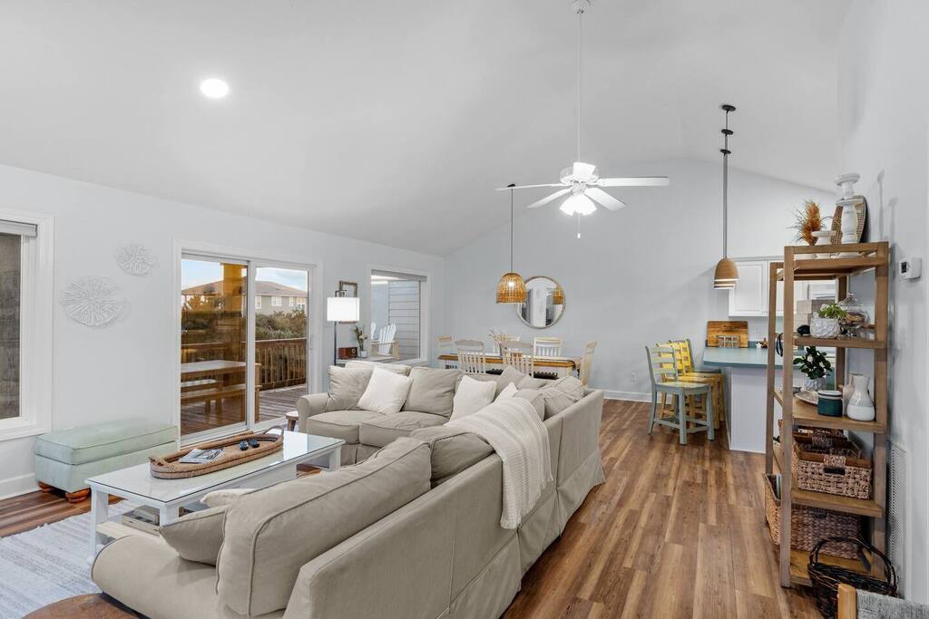 Sink into the plush sectional and enjoy your bright, open-concept retreat with warm wood floors flowing seamlessly to the dining area.