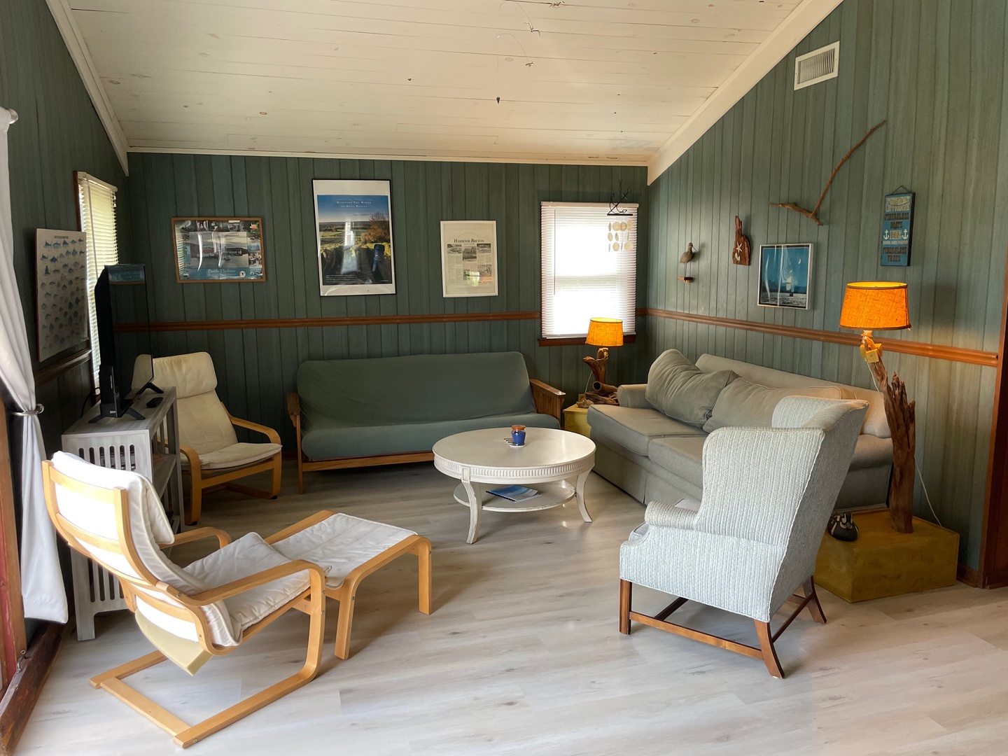 Relax in your charming nautical-themed living room with vintage furnishings, warm wood accents, and coastal decor that captures seaside serenity.