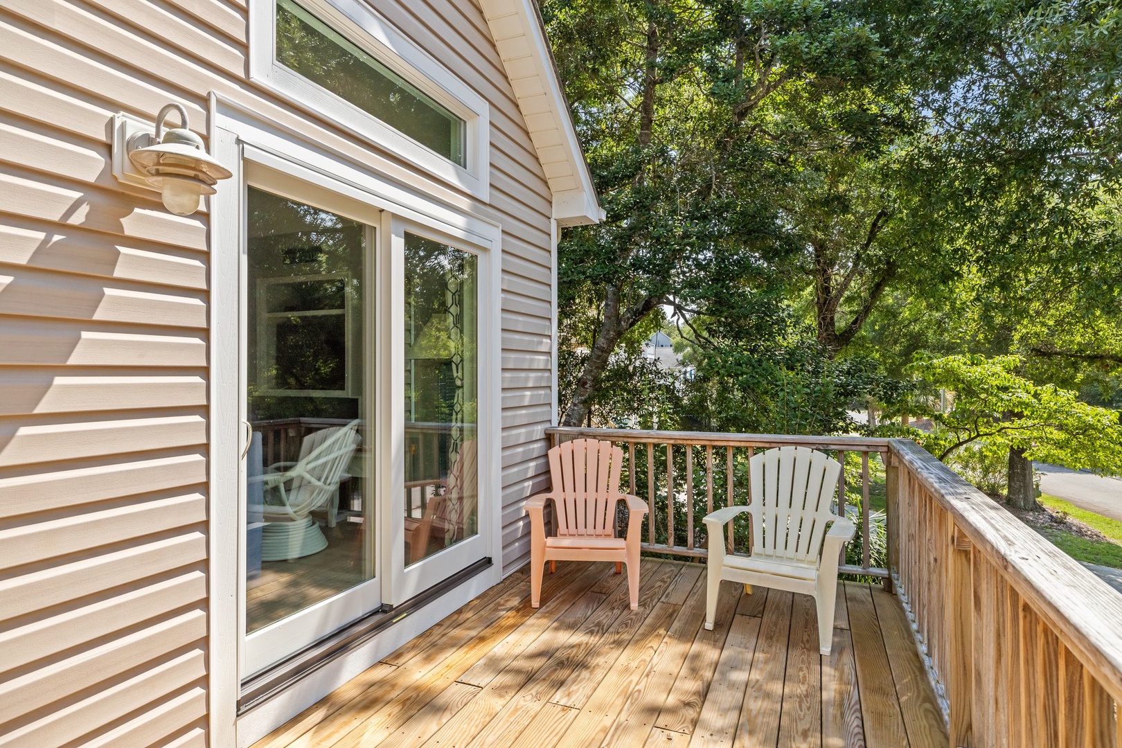 Step onto your private wooden deck where morning coffee and evening conversations feel perfect beneath leafy trees.