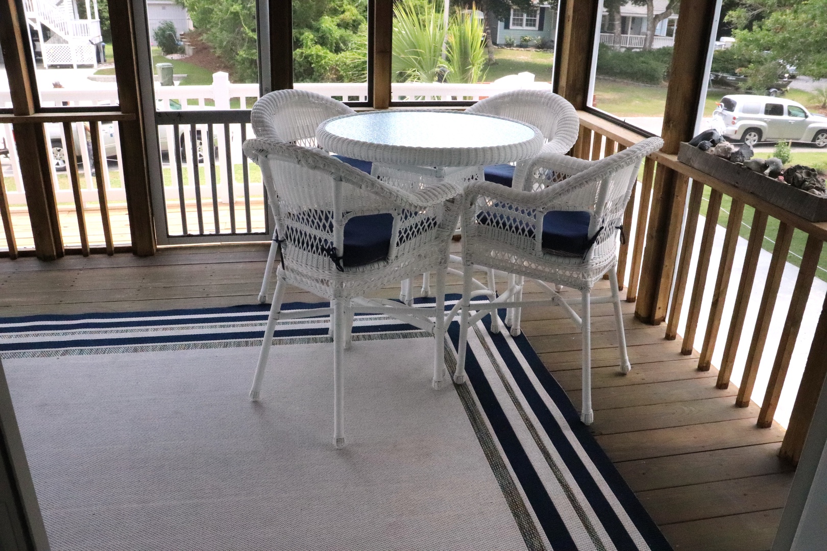 Relax on your private screened porch with wicker dining set overlooking the peaceful neighborhood—perfect for morning coffee or evening meals.