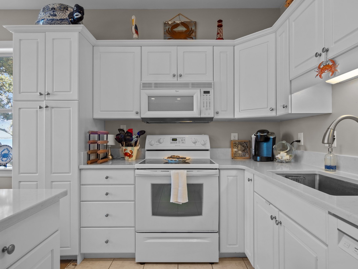 Your fully equipped kitchen features white cabinets, stainless steel appliances, and ample counter space for preparing home-cooked meals.