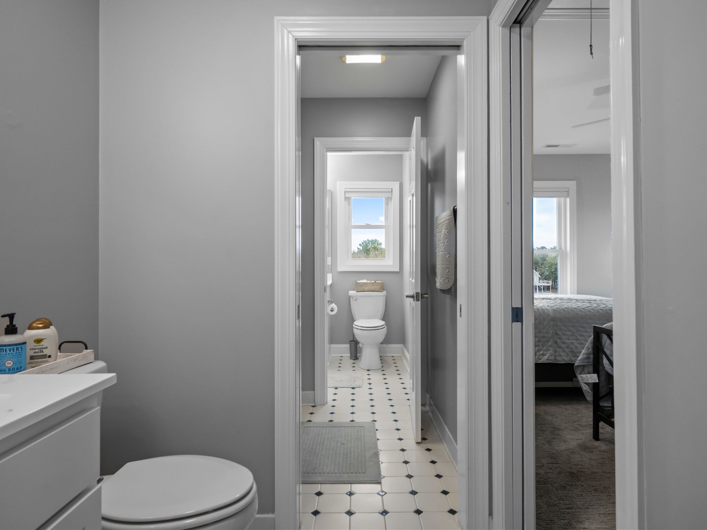 Enjoy two pristine powder rooms with charming vintage-style floors and peaceful views from your private retreat.