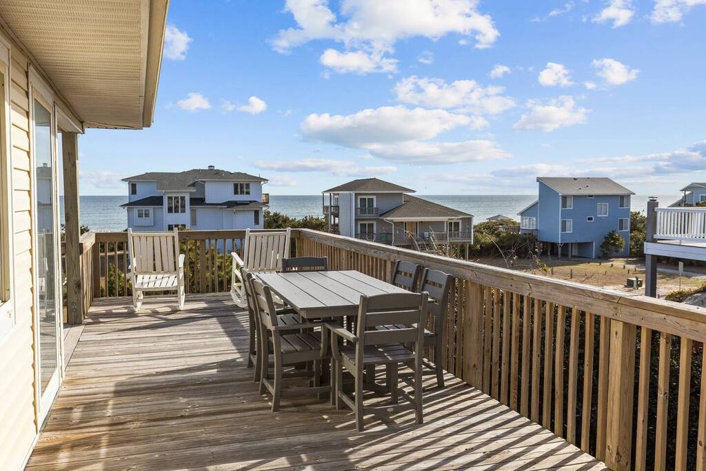 Enjoy morning coffee and ocean breezes from your private deck, with coastal views stretching to nearby beach houses.