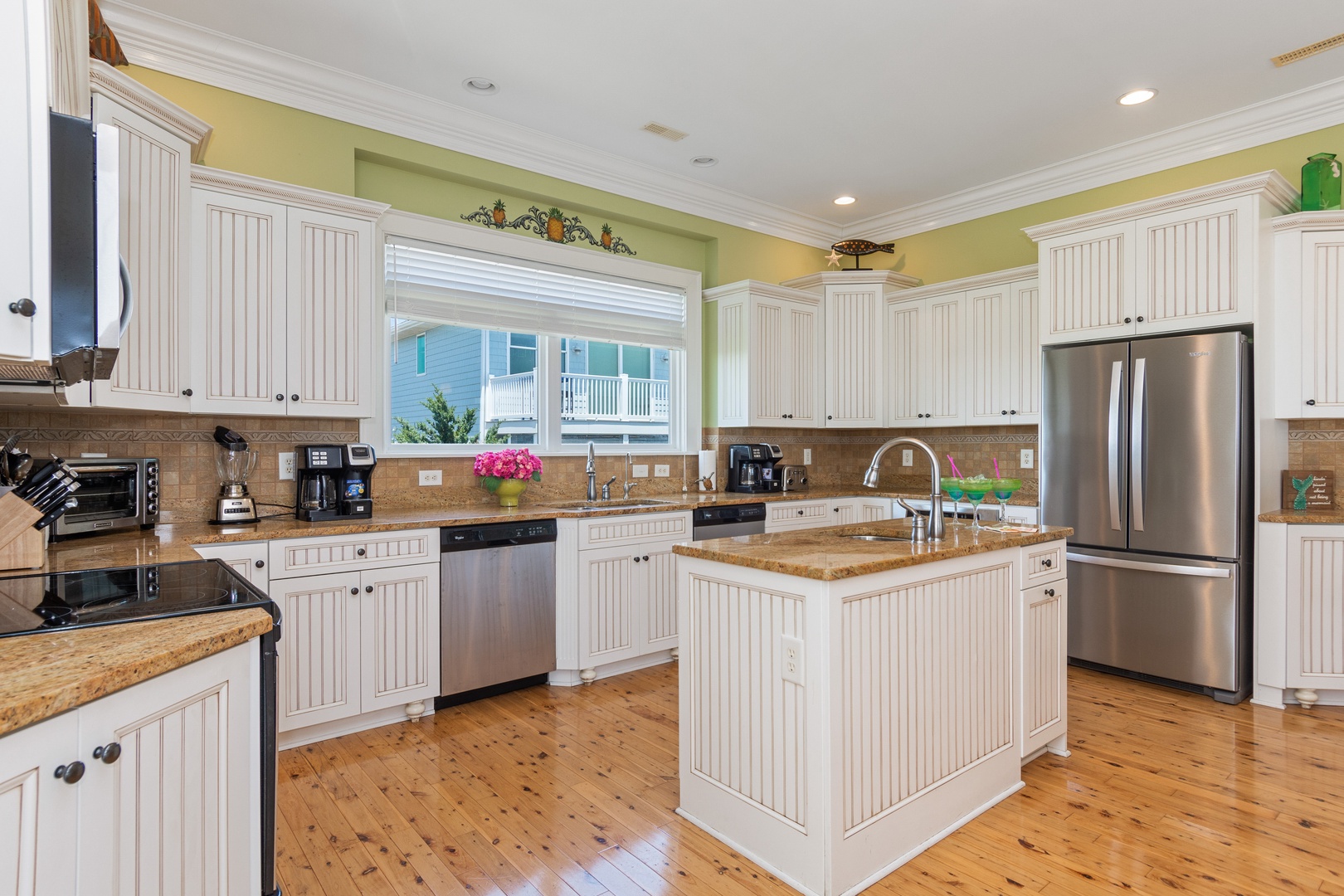 Your fully equipped kitchen features granite countertops, stainless steel appliances, and a spacious island perfect for cooking memorable meals together.