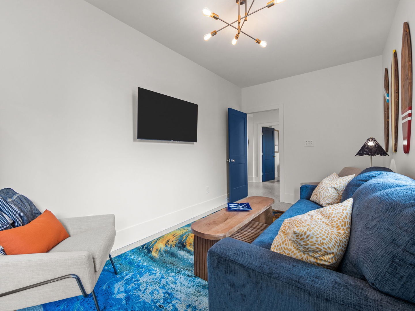 Settle into this bright living space where soft furnishings and ocean-inspired decor create your perfect retreat for movie nights and relaxation.
