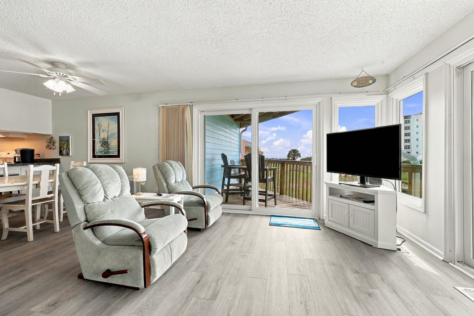 Settle into the plush recliners and soak in the peaceful atmosphere. Open the glass doors to your private balcony and let the fresh air and natural light pour in, creating your perfect relaxation spot.