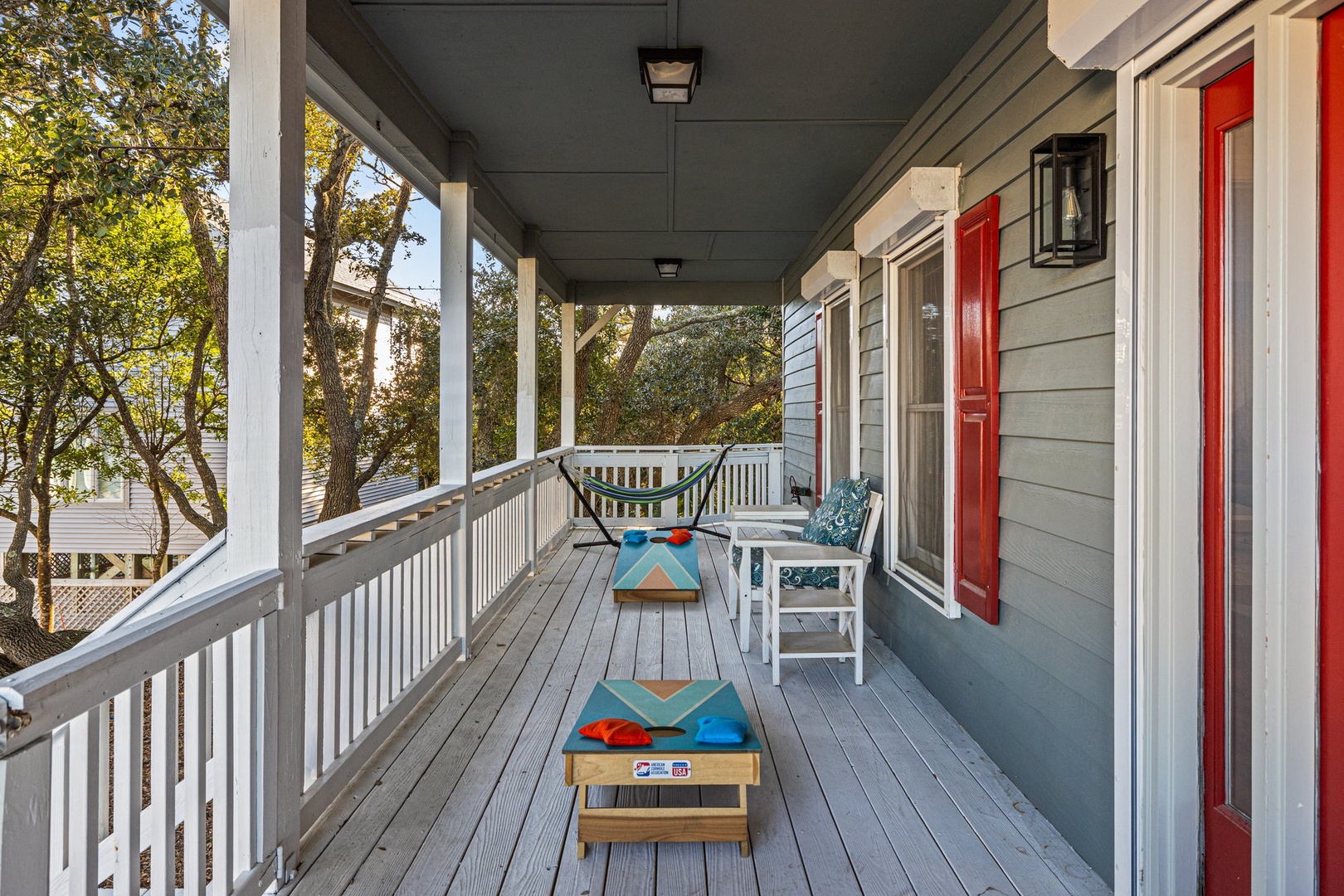 Your private deck awaits with corn hole games and cozy seating—perfect for morning coffee or sunset relaxation.