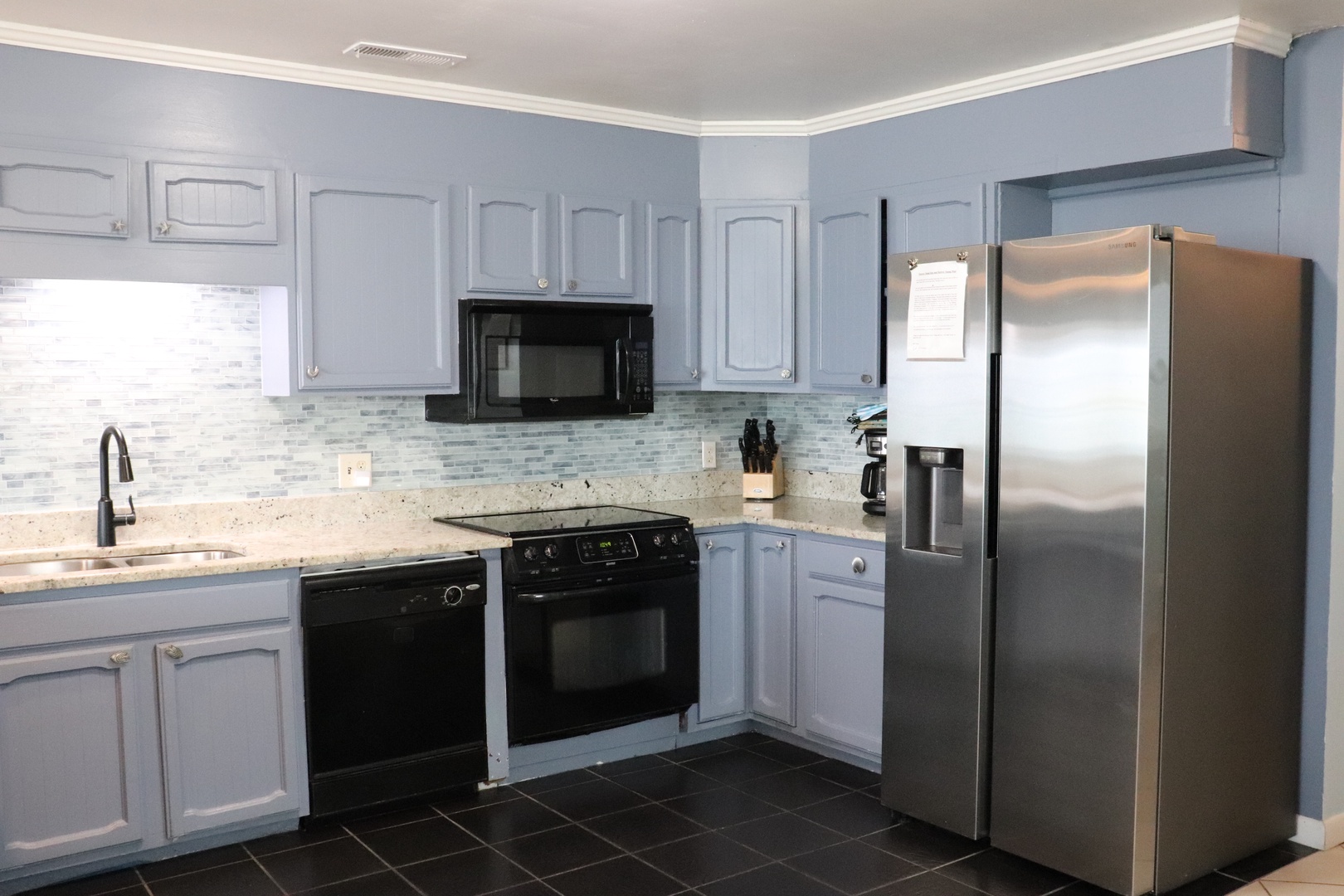 Your fully equipped kitchen awaits with modern appliances, sleek granite countertops, and plenty of cabinet space—perfect for preparing your favorite meals during your stay.