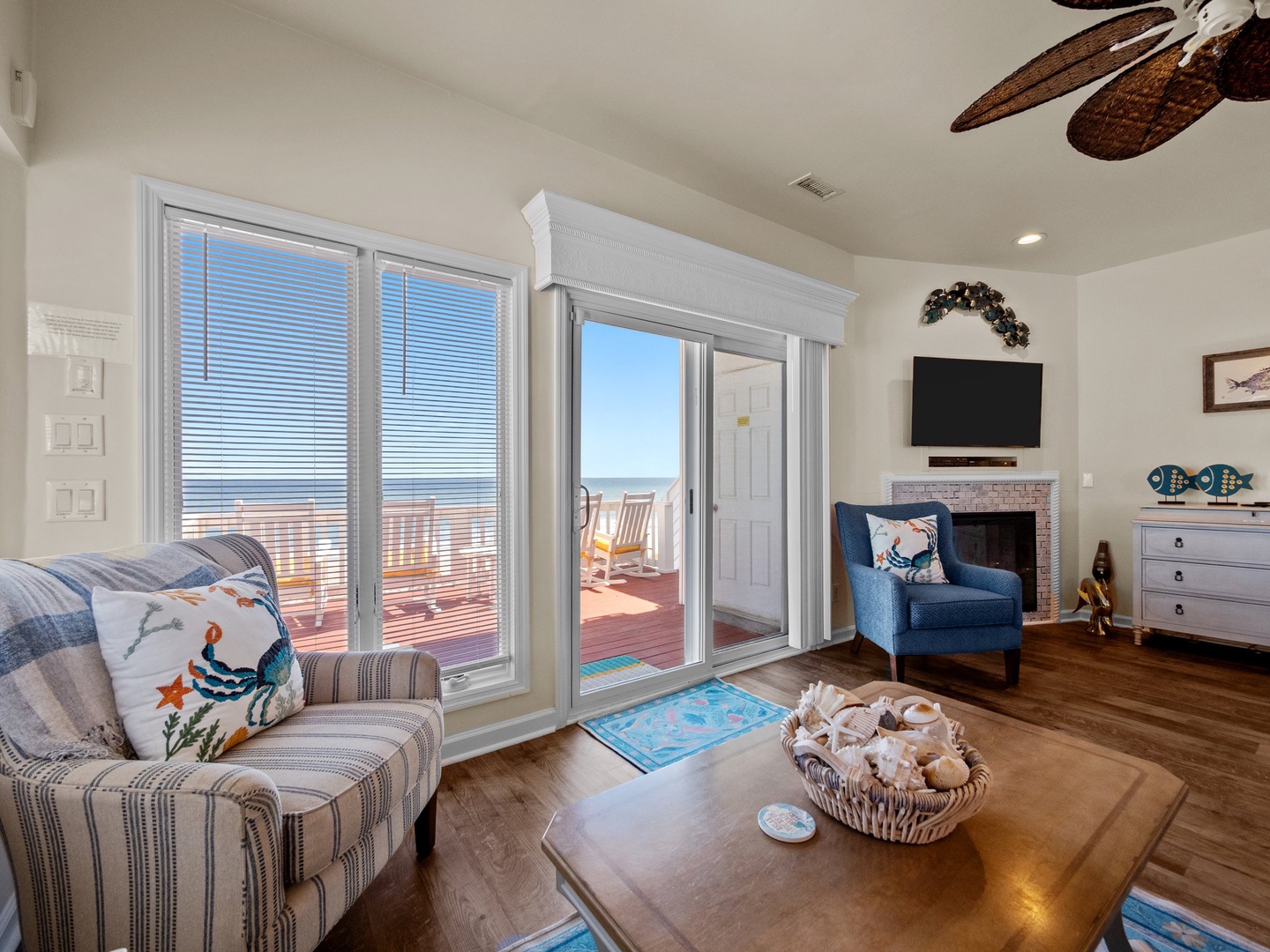 Relax in your coastal living room with ocean views through glass doors opening to your private deck.