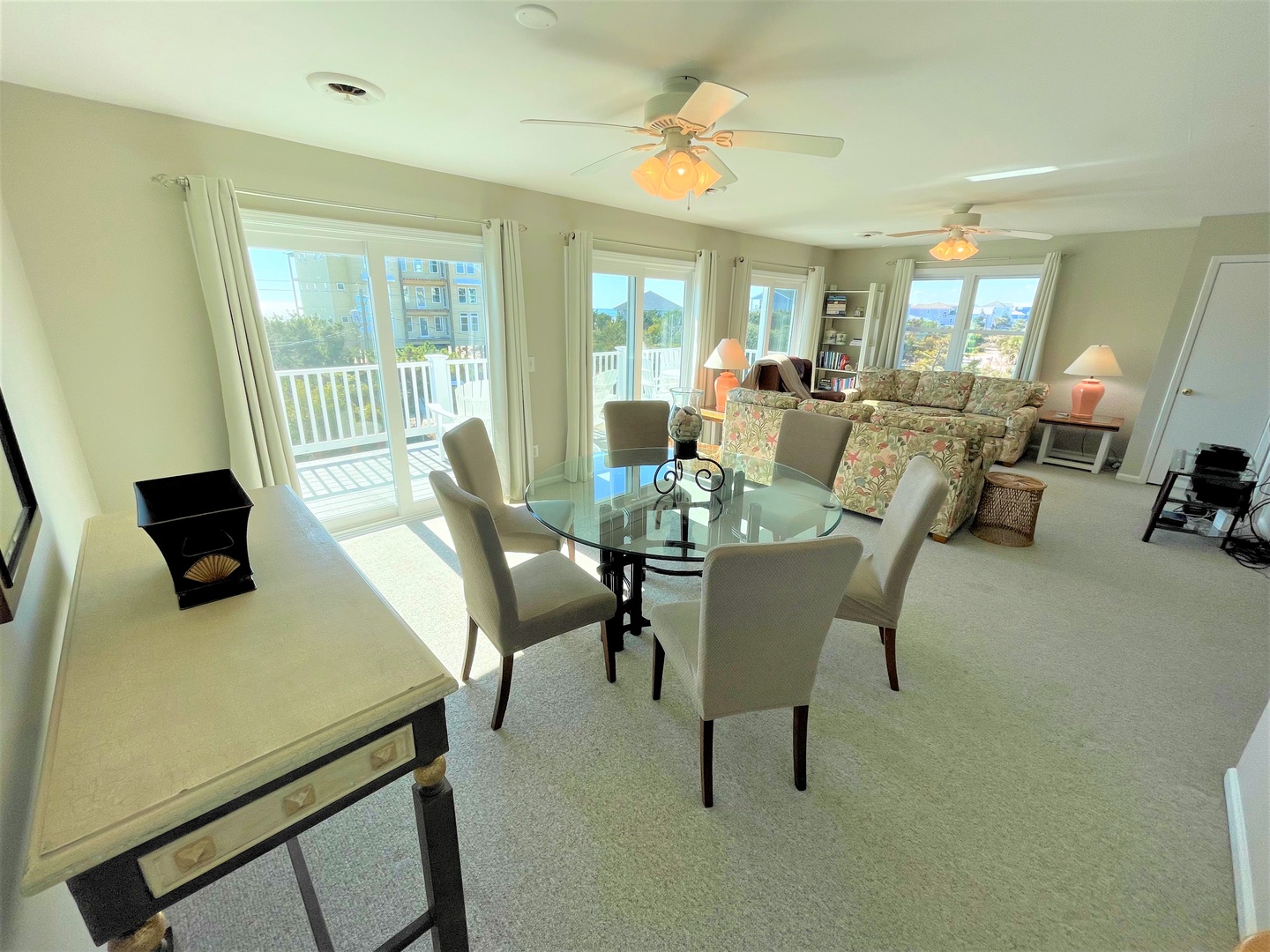 Your bright, open living space flows seamlessly from dining to lounging, with panoramic windows framing city views and coastal vistas beyond.