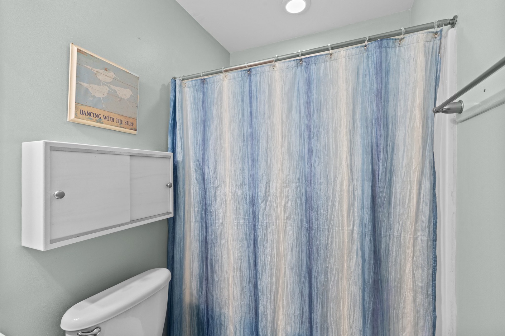 Relax in your coastal-themed bathroom featuring soothing ocean-inspired décor and modern amenities for your comfort.