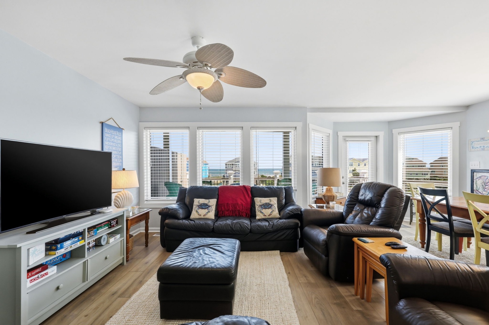 Your bright coastal living room invites you to relax in plush leather seating while enjoying breathtaking ocean views through expansive windows. Gather for movie nights or simply unwind with the soothing sea breeze.