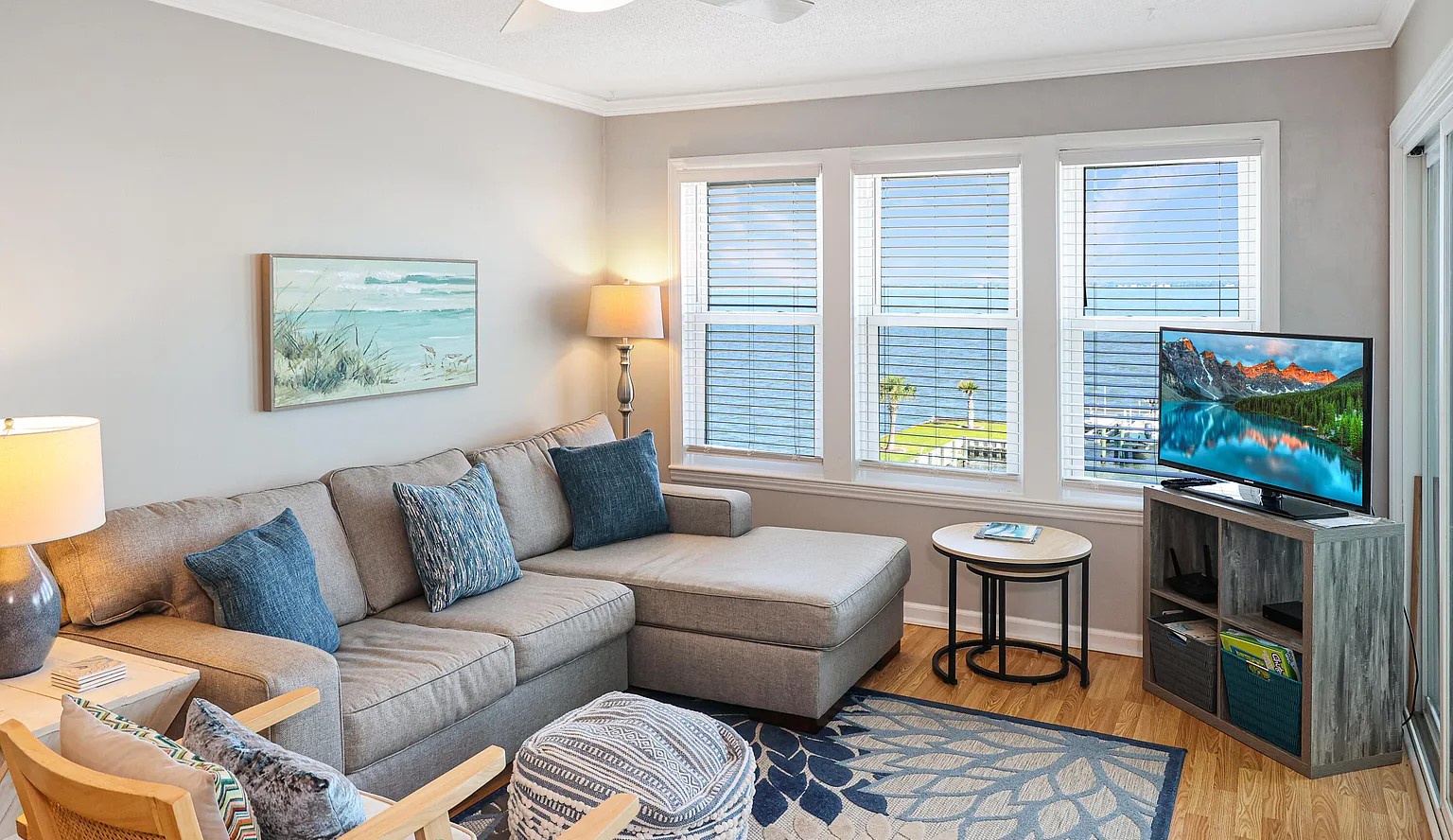 Sink into your comfortable sectional sofa and unwind in this bright living space, complete with entertainment center and coastal-inspired decor.