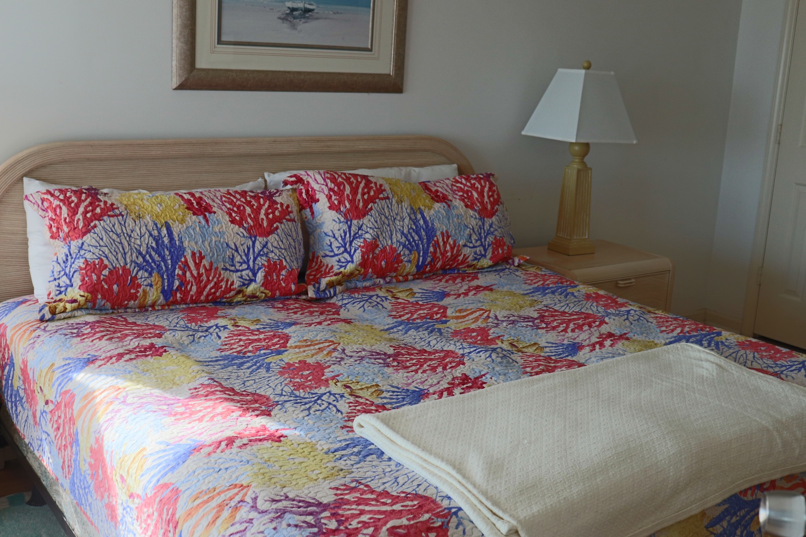 Drift off to sleep surrounded by vibrant coral reef bedding and coastal charm in your comfortable bedroom retreat.