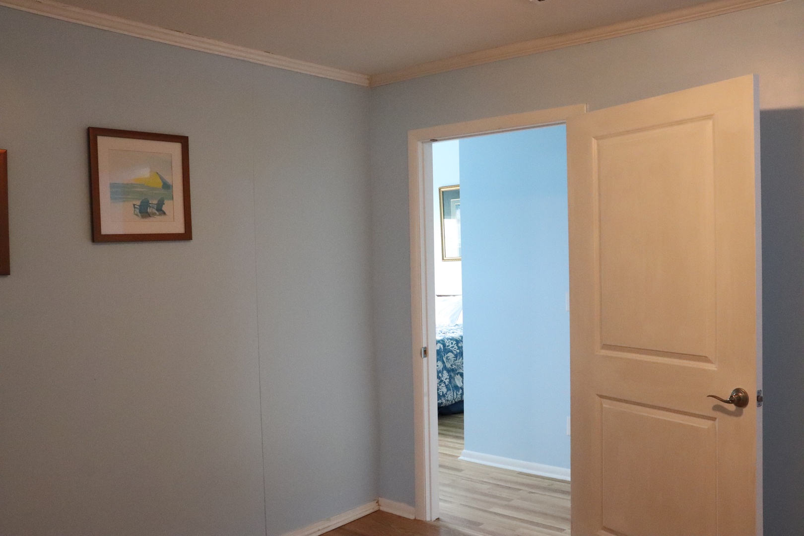 Step into your peaceful retreat, where soft blue walls and warm wood floors lead you to cozy bedrooms awaiting your arrival.