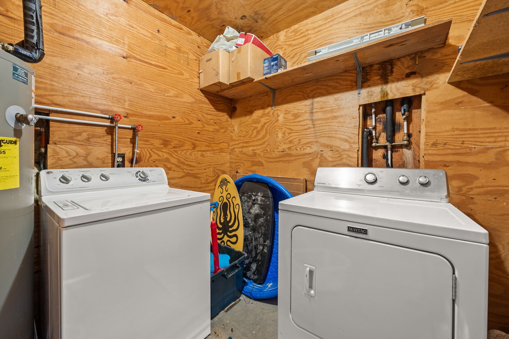 Your laundry needs are covered with convenient washer and dryer tucked away in this cozy wood-lined utility space.