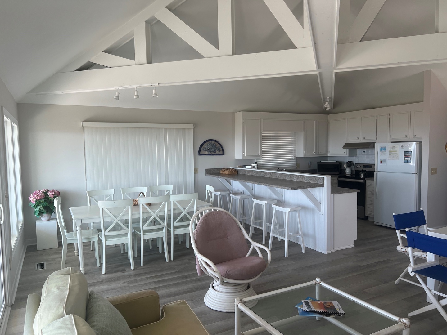 Relax in this bright, open living space where exposed beams and coastal-chic décor create your perfect beach house retreat.
