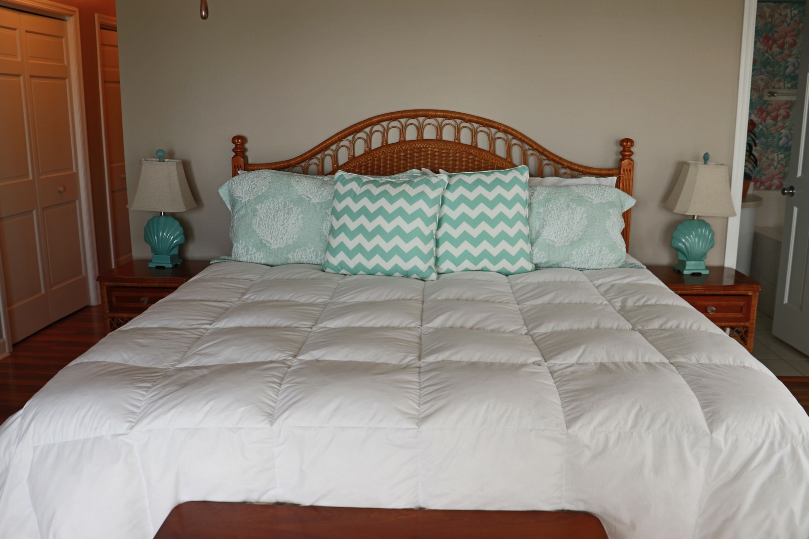 Drift into peaceful sleep in your beautifully appointed bedroom, featuring a plush quilted comforter and charming coastal-themed pillows that set the perfect tone for relaxation.