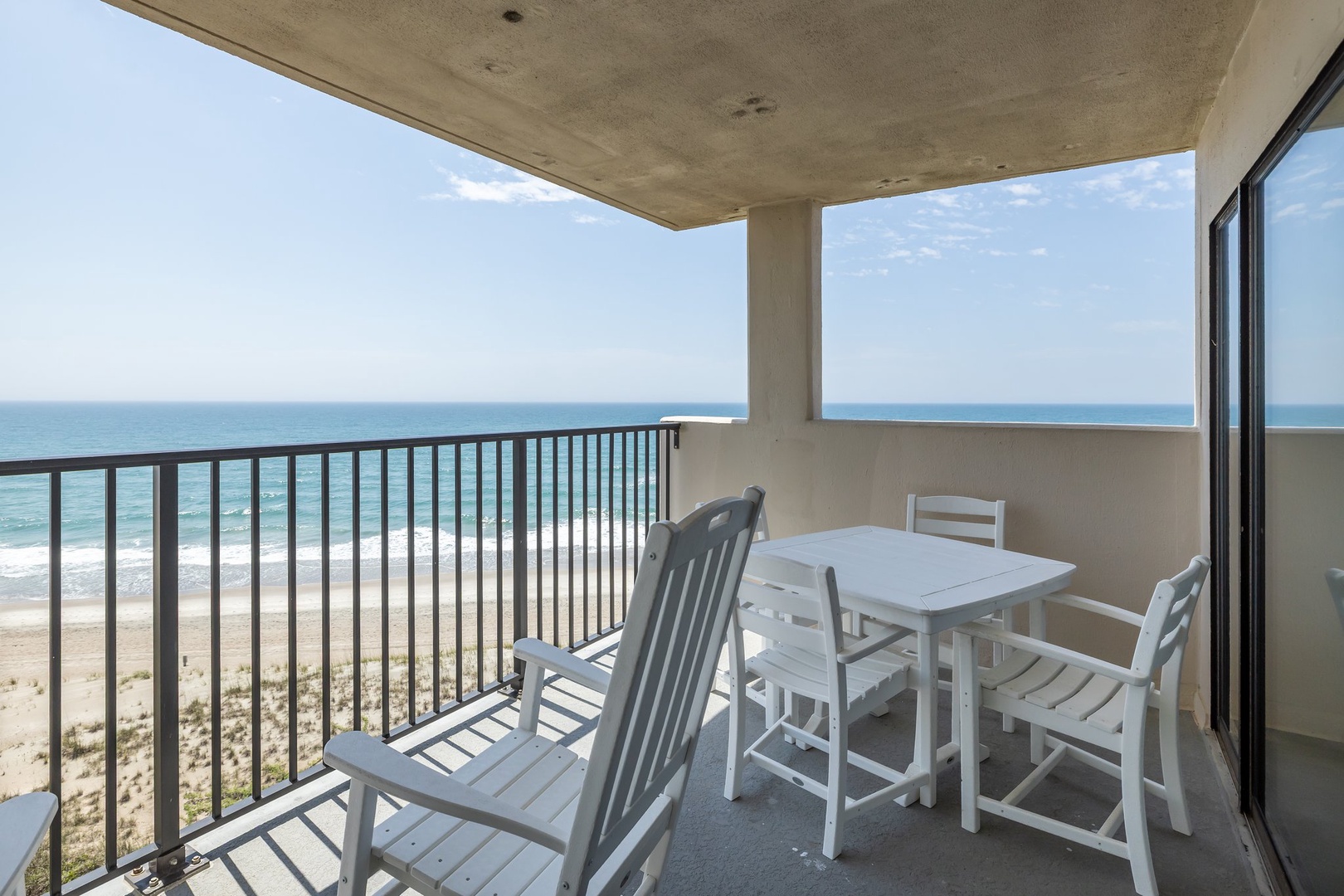 Savor morning coffee on your private balcony as ocean waves meet endless sandy shoreline below.