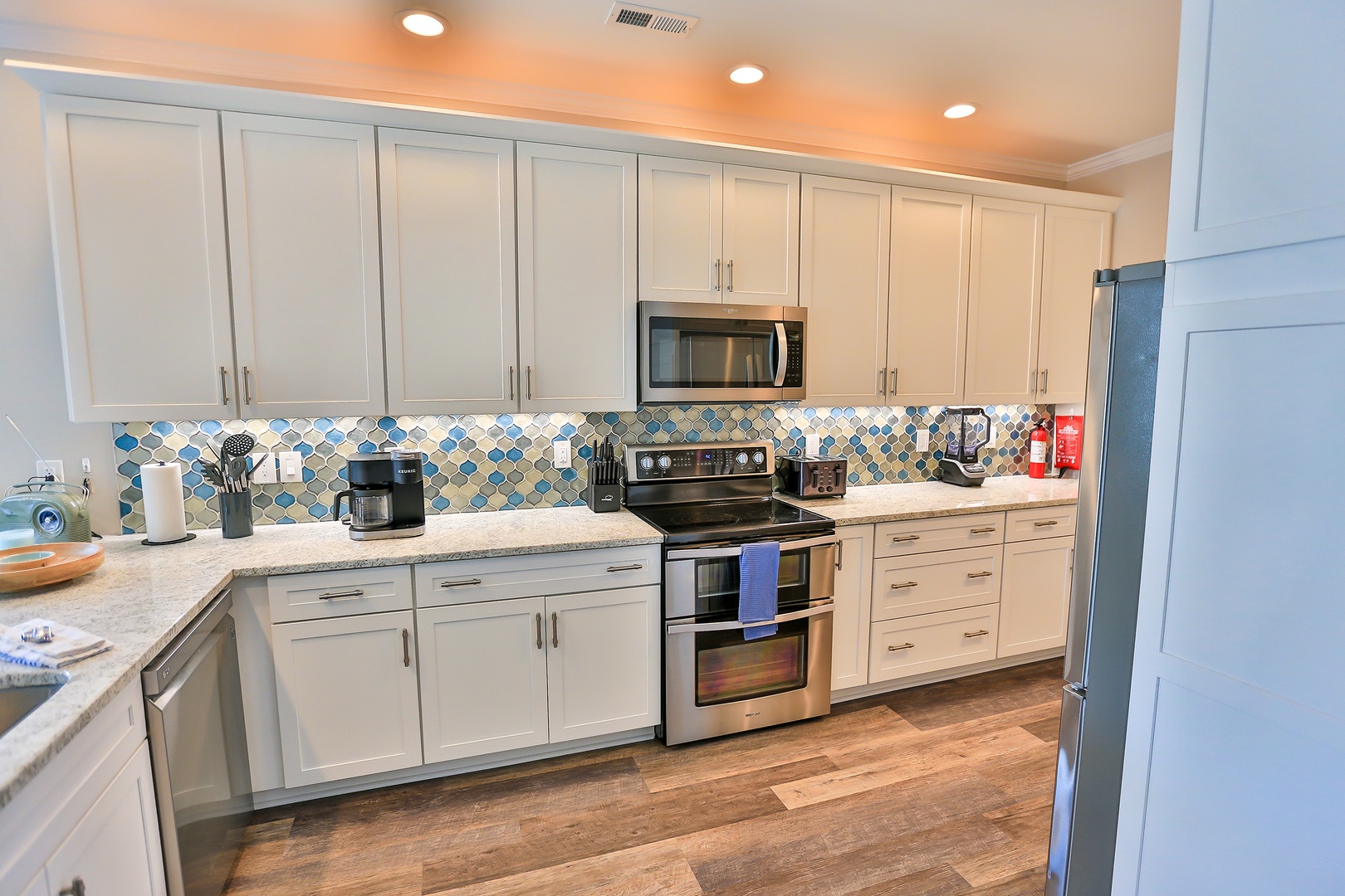 You'll love cooking in this bright kitchen with stainless steel appliances, colorful backsplash, and plenty of cabinet space for all your vacation meal prep needs.