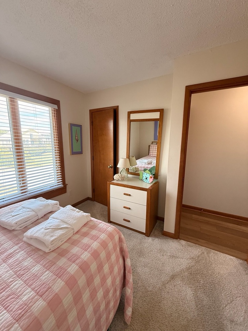 Sink into soft linens and wake to warm natural light streaming through your window. This cozy bedroom offers peaceful rest with thoughtful touches and a serene, homey feel.