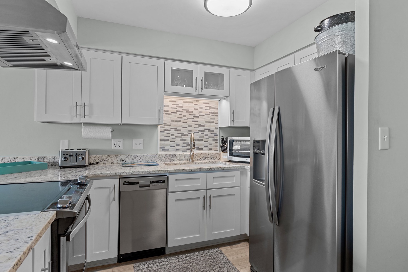 Your modern kitchen features stainless steel appliances, granite counters, and white cabinets—everything you need for home-cooked meals.