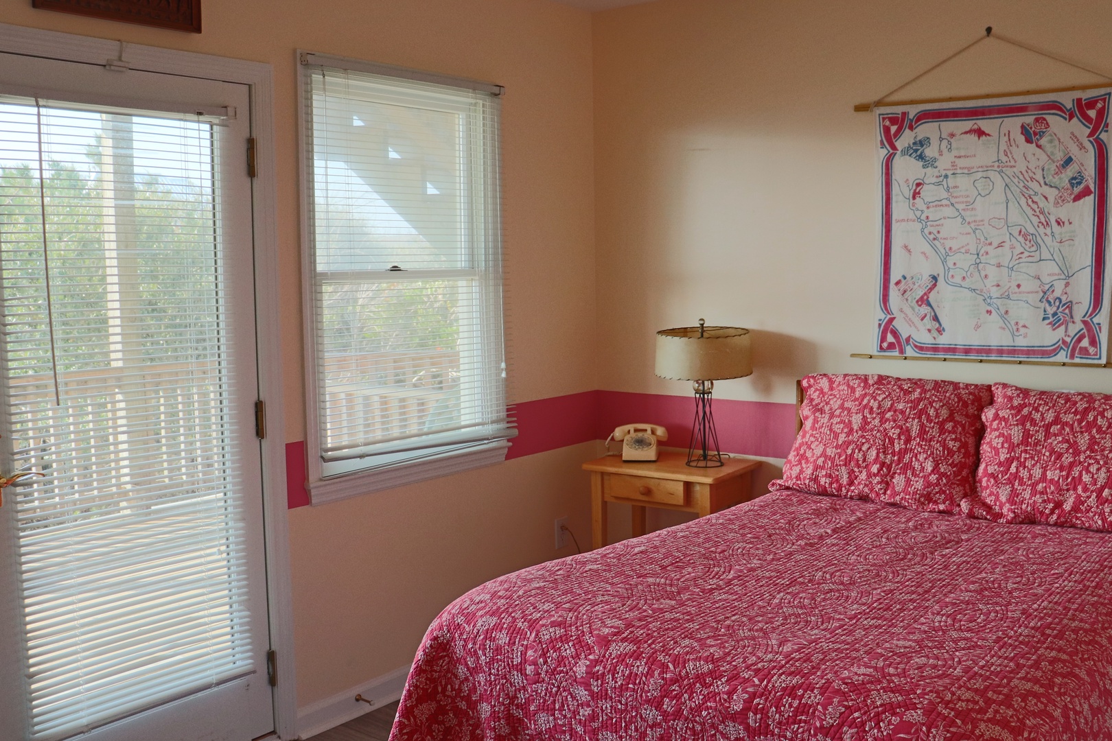 Unwind in your cozy bedroom featuring vibrant red linens and charming vintage touches that create a warm, nostalgic retreat.