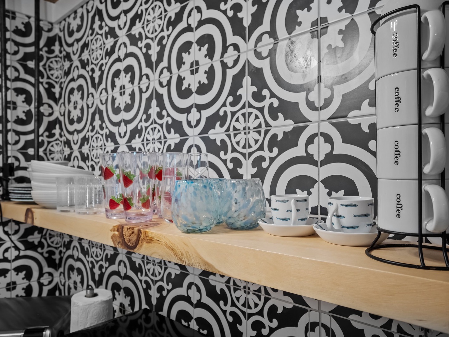 Start your mornings with beautifully organized dishware and coffee essentials, all set against stunning patterned tiles in your stylish kitchen.